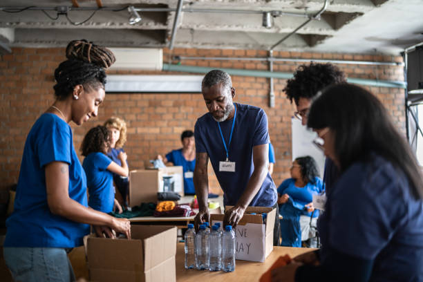 Home Volunteers arranging donations in a community charity donation center